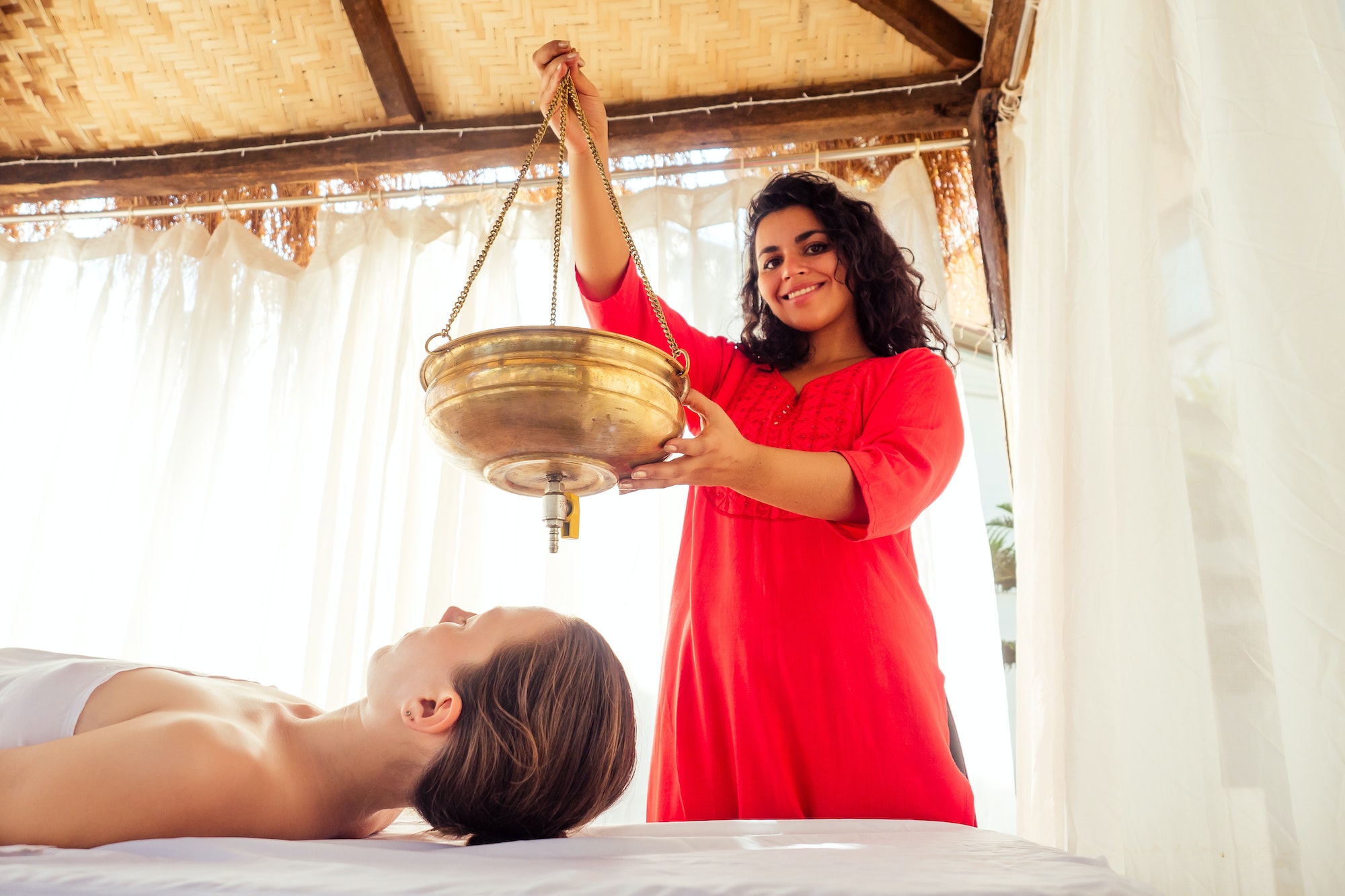 young woman doing healthcare indian traditional treatment in Ayurveda body constitution centre